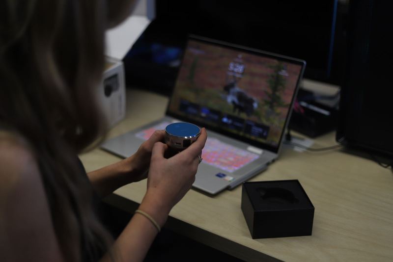 A member holding a small sensor in the lab
