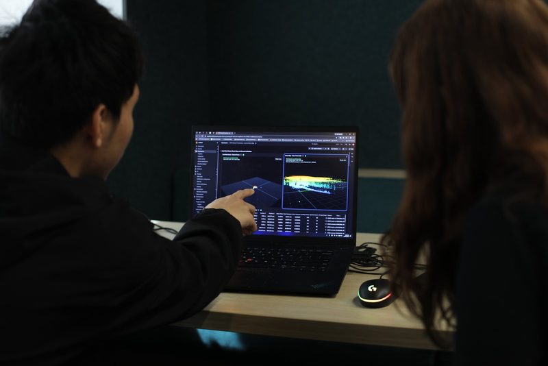 Two VISTA members reviewing a LiDAR point cloud on a laptop